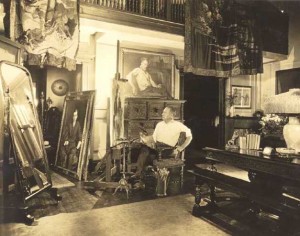 40:4  The artist in his Hotel des Artistes Studio, New York City.  At left, portrait of Will Hayes.  Above, self-portrait.