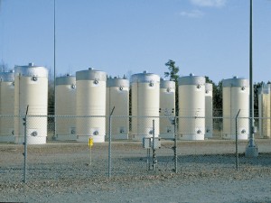 Dry cask storage behind secure fencing.