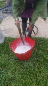 Stirring Kaolin Clay solution with the broken handle of an old digging fork. 