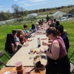 Lafayette Staff enjoying lunch outdoors at LaFarm