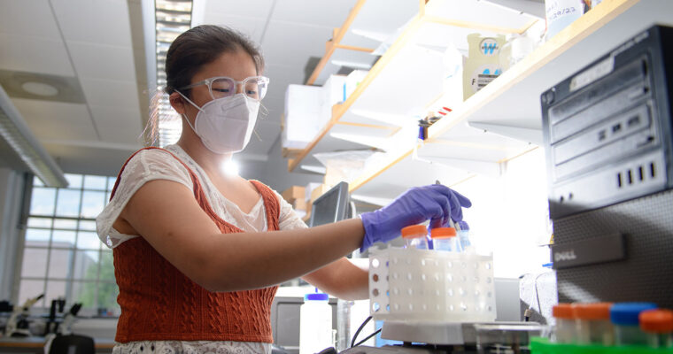 Anna operating the QCM-D in her undergraduate research.