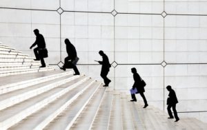 Businessmen walk up stairs, financial district