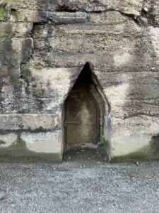 small door of an air raid shelter built into concrete