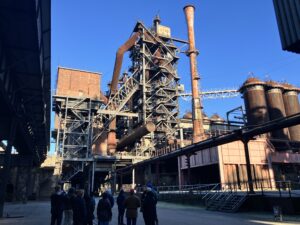 scaffolding surround a blast furnace 100 feet tall.