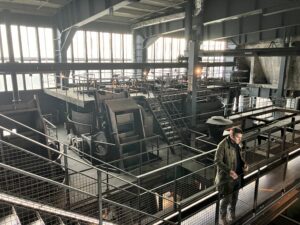 tour guide standing on a catwalk of a coal washing factory