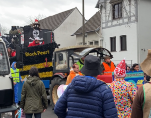 Carnival Barge drives by crowd of people