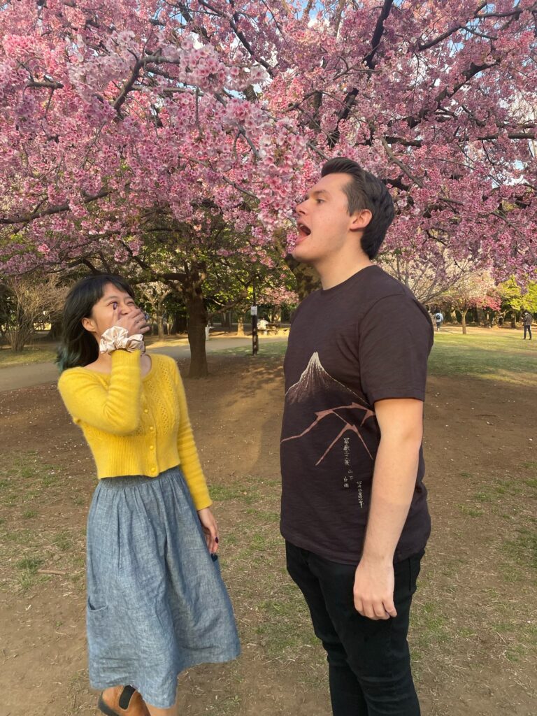 Josh and Shirley eating and laughing at cherry blossoms