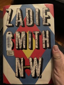 Cover of Zadie Smith's novel NW, held by my hand