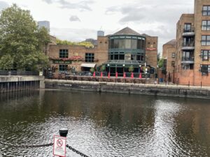 Brick and glass pub behind bricked-in lake