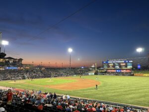 A view of sunset at a baseball game.