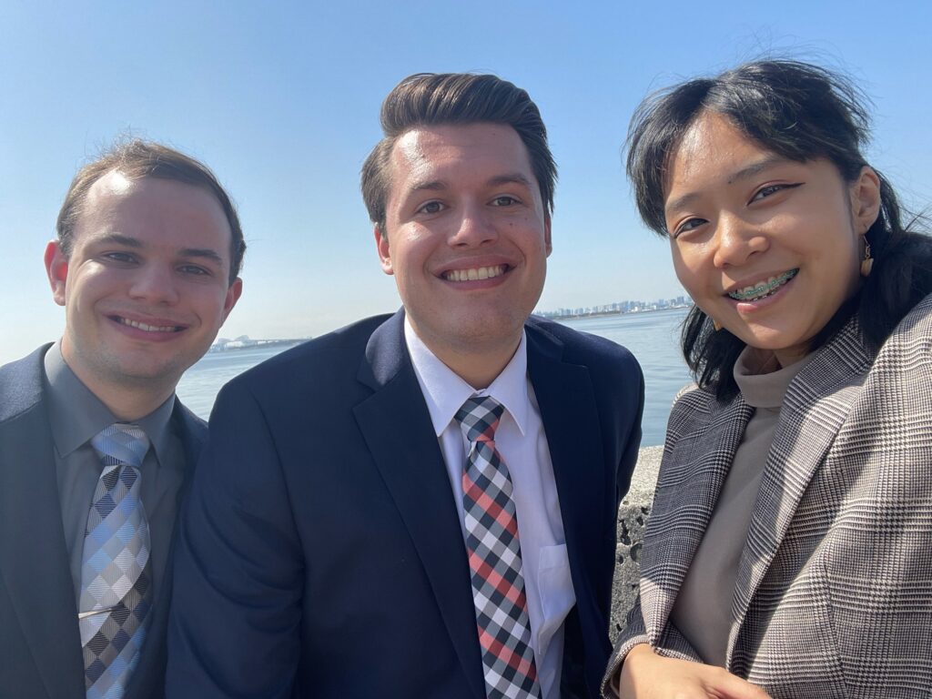 Ben, Josh, and Shirley on the breakwall by the Pacific Ocean