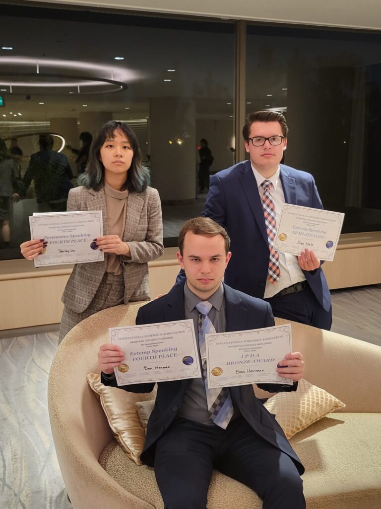 Shirley, Ben, Josh posing with awards